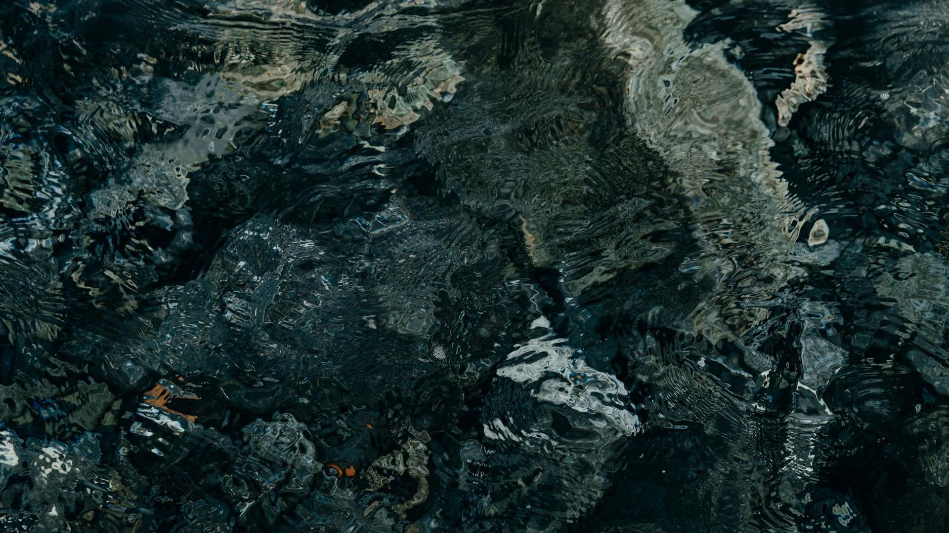 A person in a calm state of motion against a dark, minimalist background.